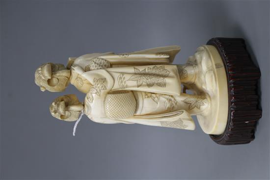 A Japanese Tokyo School carved ivory group of two geisha, late Meiji period, signed, height 18cm, overall height 21cm